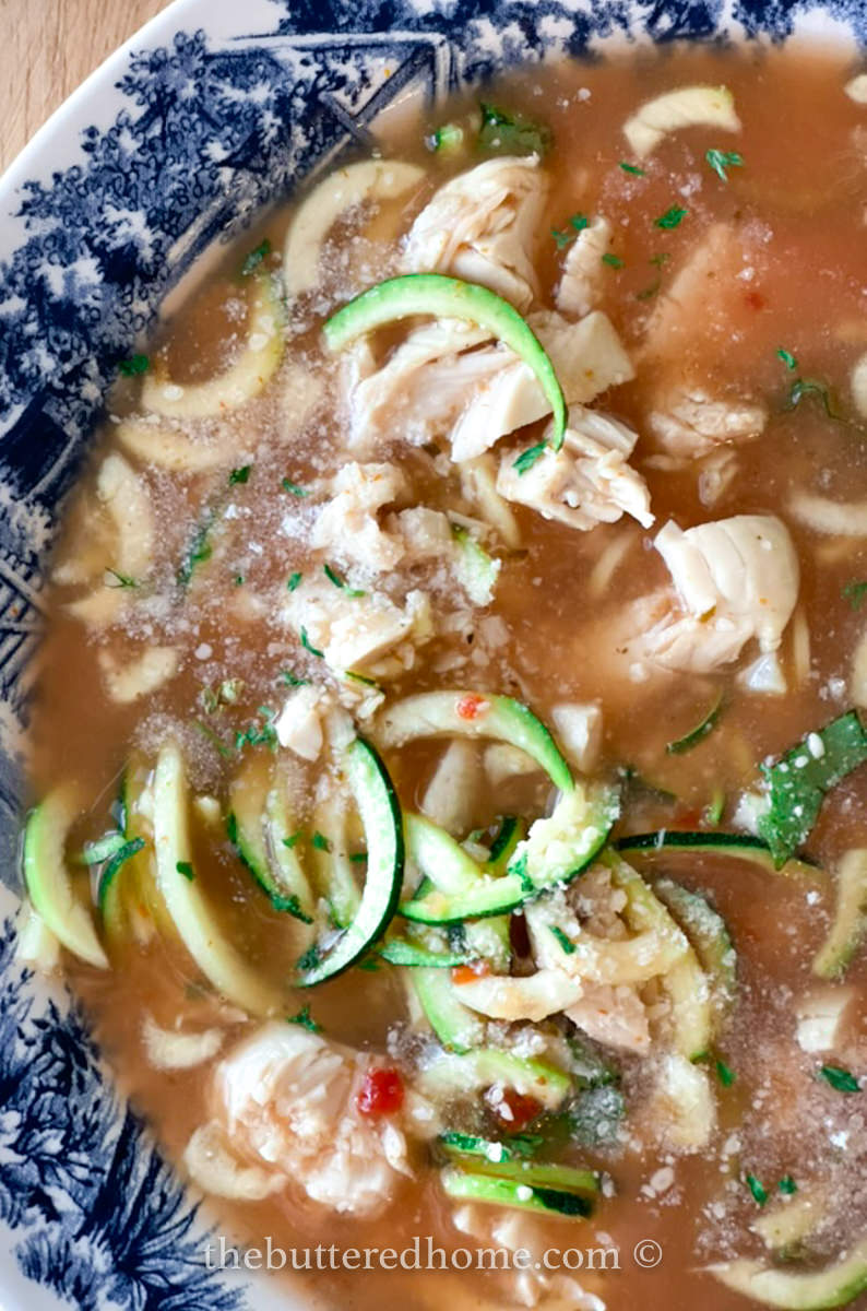 close up of zucchini noodles and chicken soup