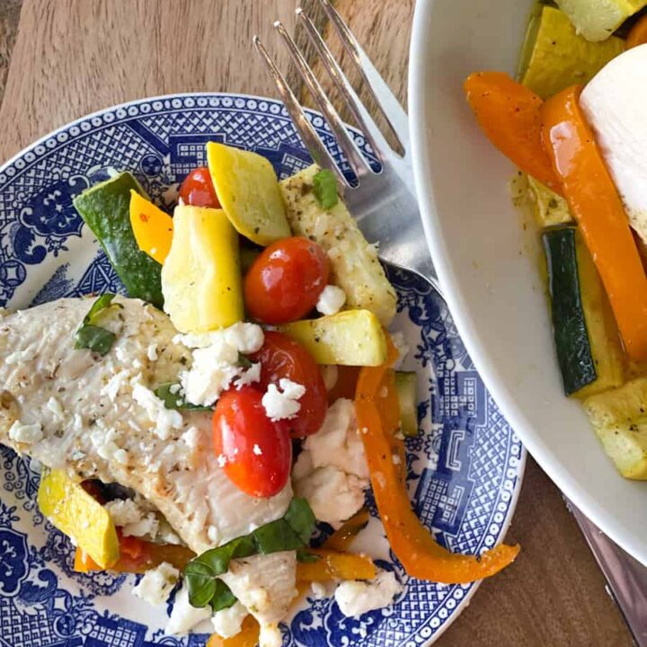 overhead view of chicken and veggies on a blue plate