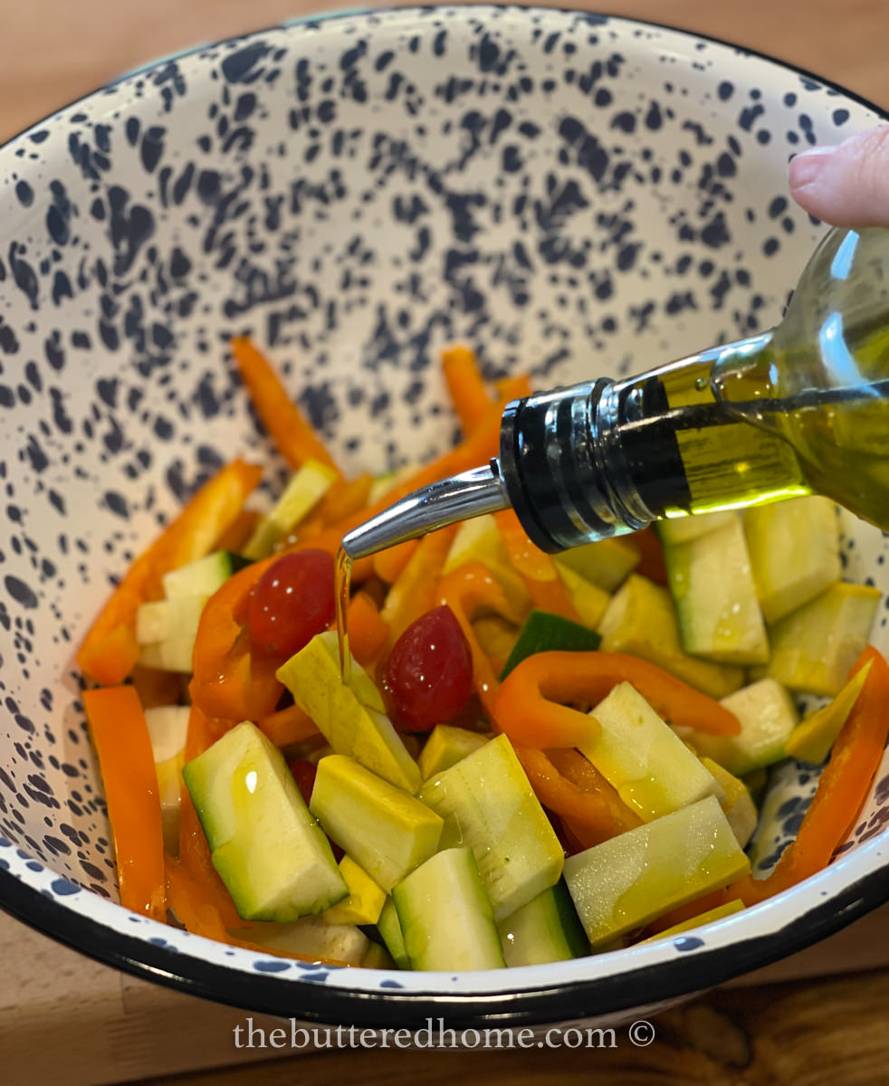 adding olive oil to vegetables