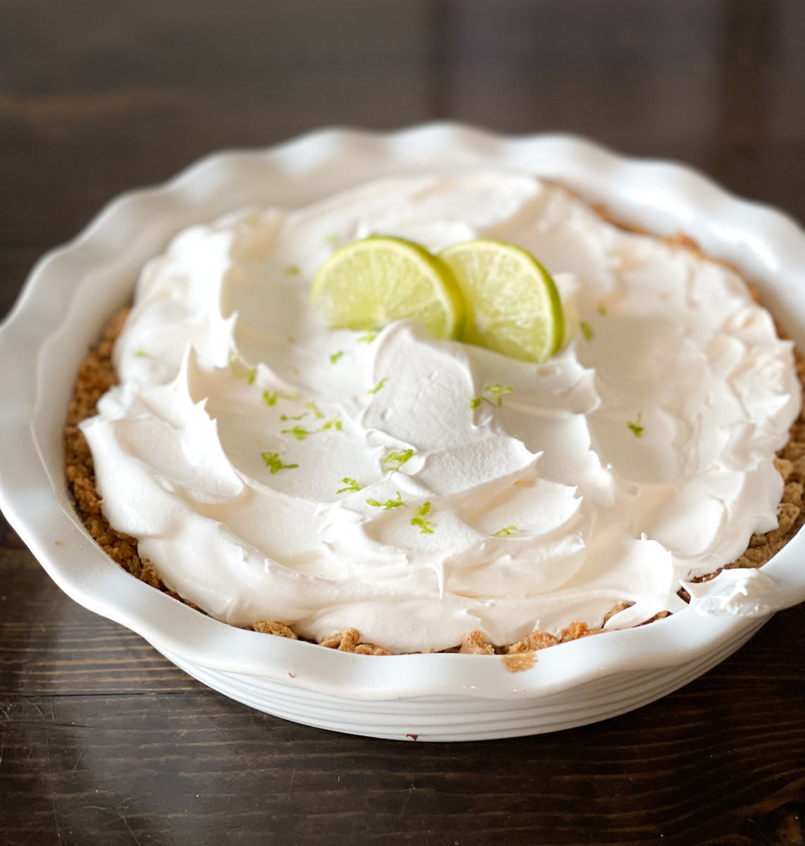 whole key lime pie garnished with lime slices