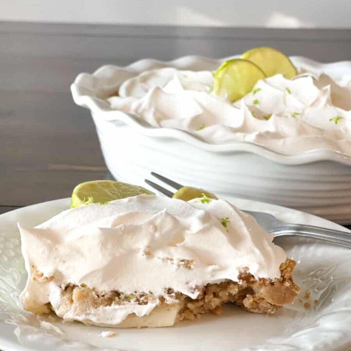 a slice of key lime pie on a white plate