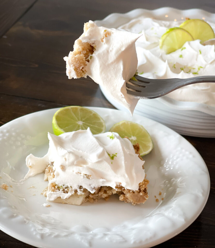 a slice of key lime pie with a bite on the fork