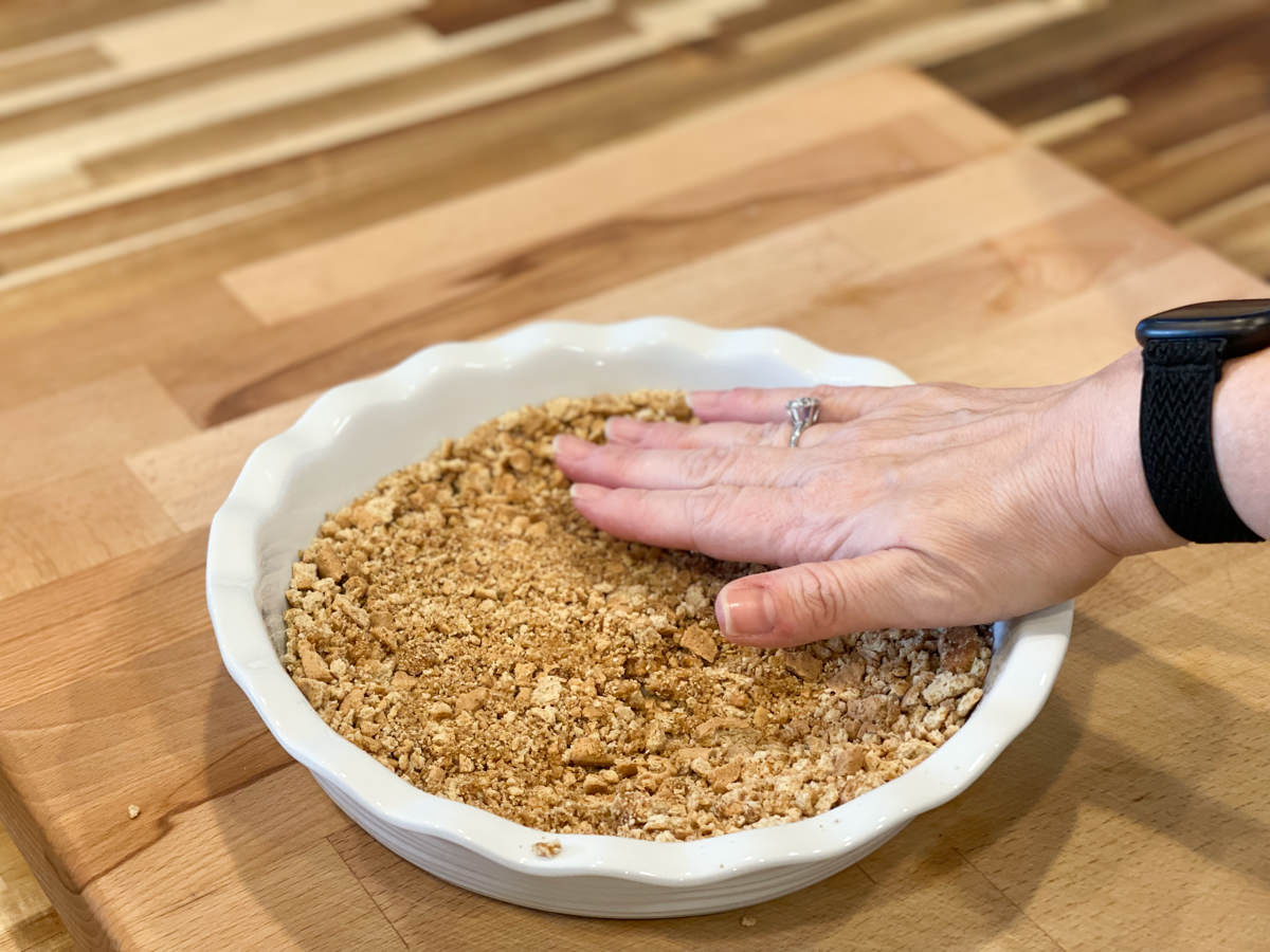 patting out crust for pie