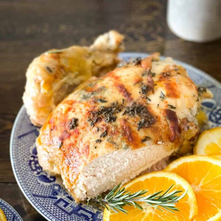 whole slow cooked chicken on a blue and white platter