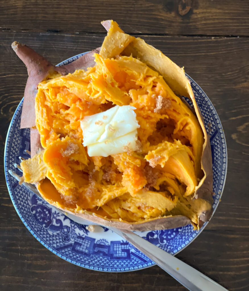 sweet potato and butter on a blue and white plate
