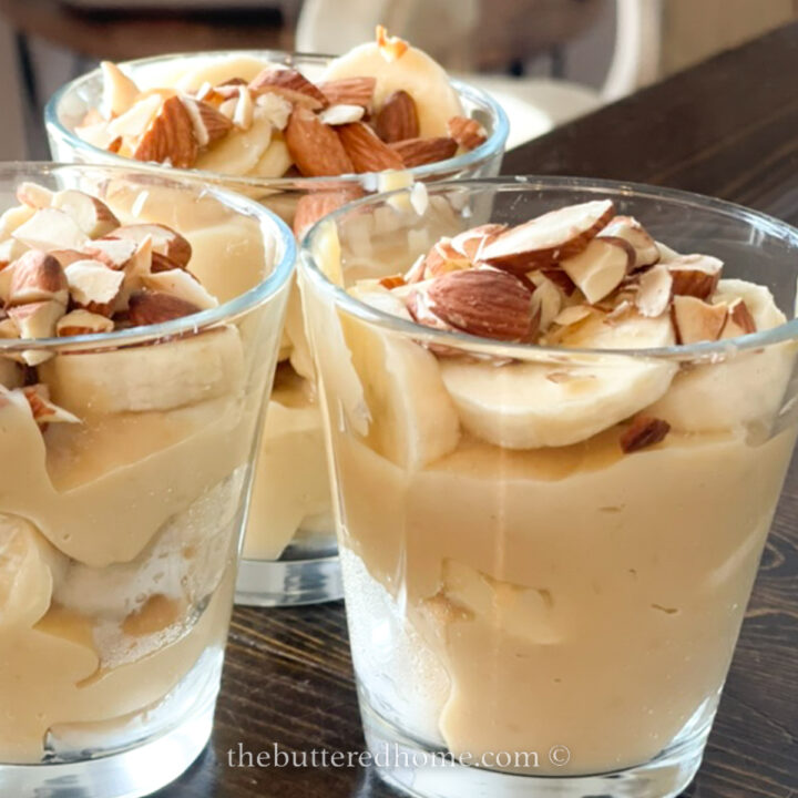 banana pudding topped with almonds in clear cups
