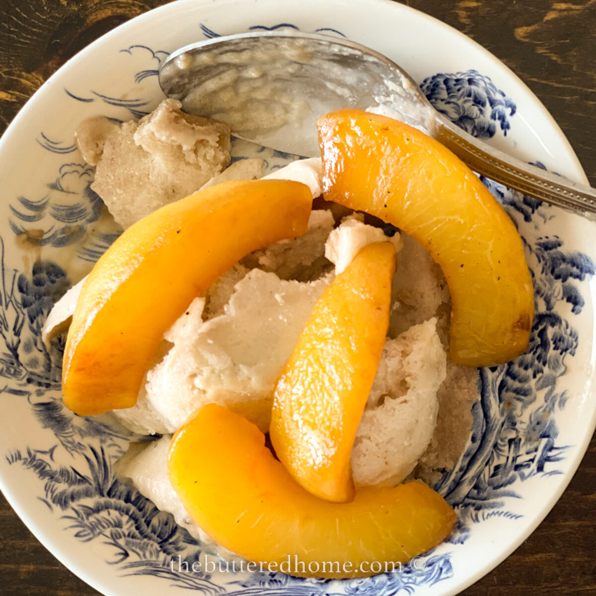 peaches in a blue willow patterned bowl