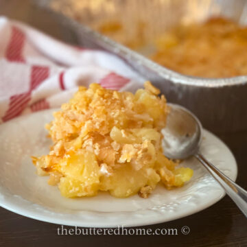 pineapple cheese casserole on a white plate