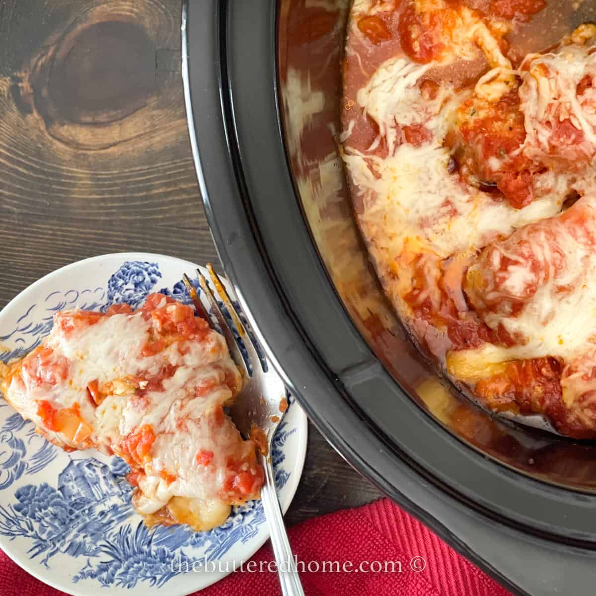 serving of chicken parm with crock pot nearby