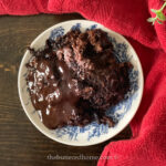 lava cake in a blue and white bowl with a red towel around