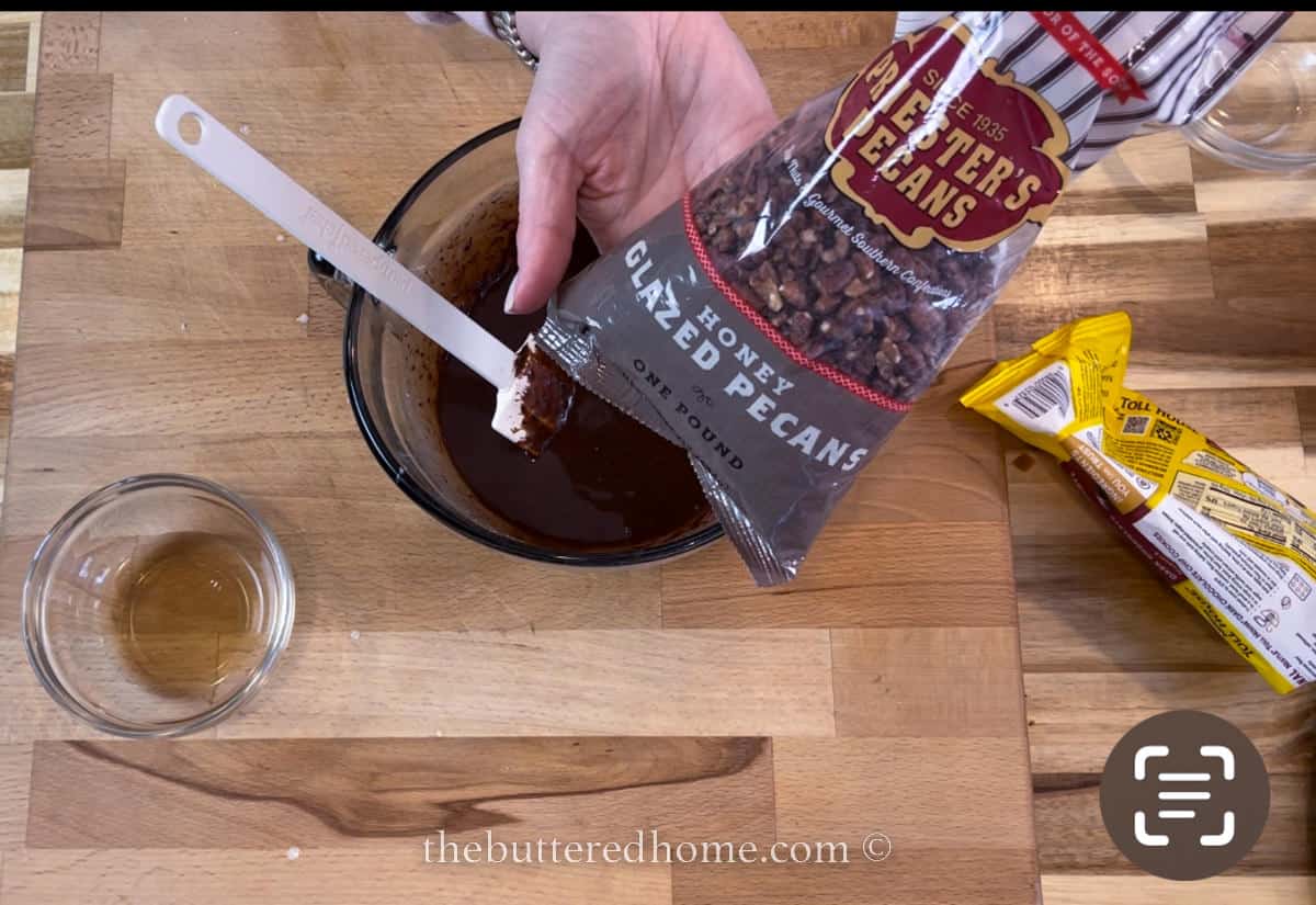 adding chopped pecans to chocolate