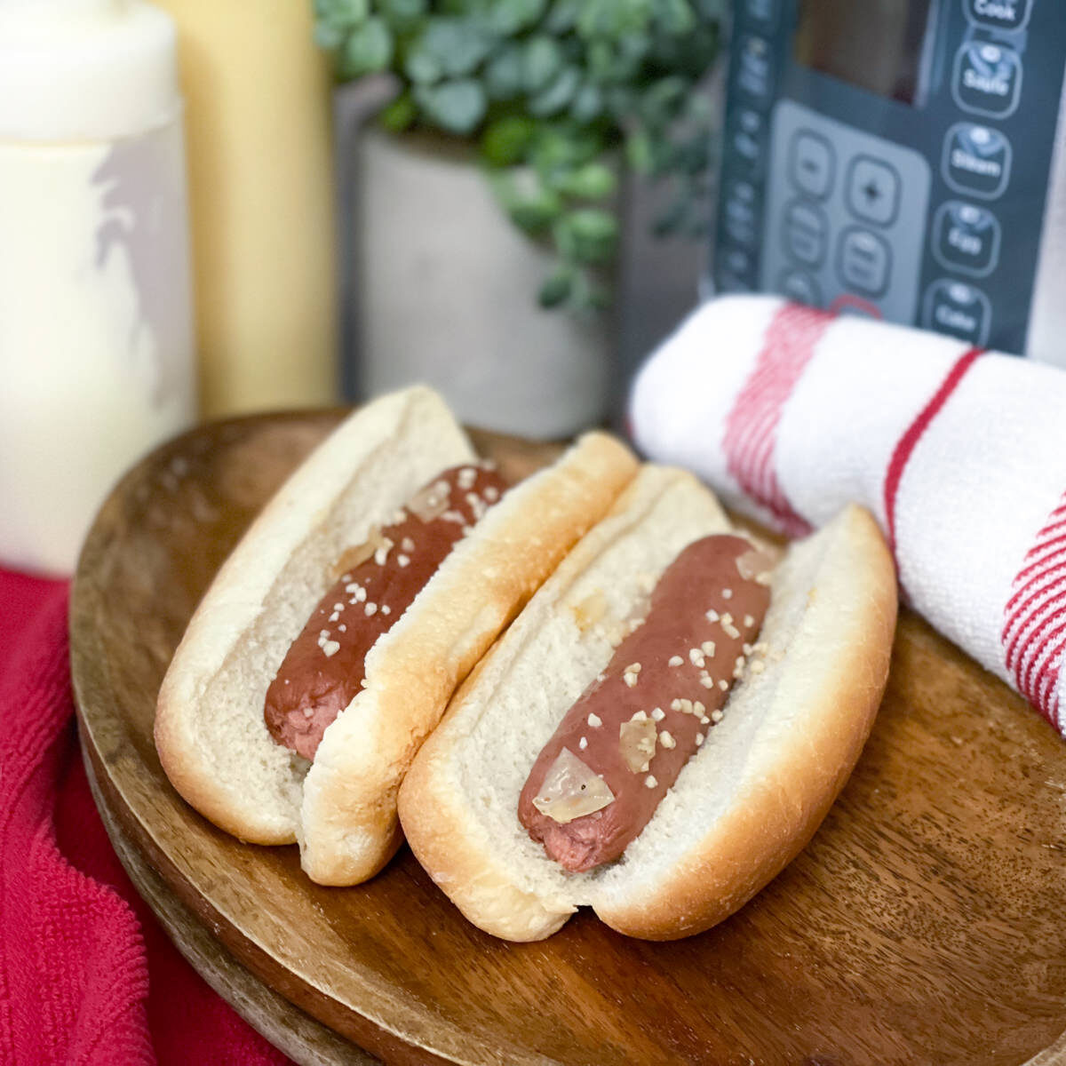two hot dogs on a wooden platter
