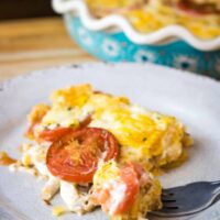 a bite of tomato pie on a grey plate