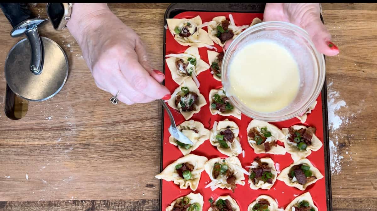 adding the cream mixture to the tarts.