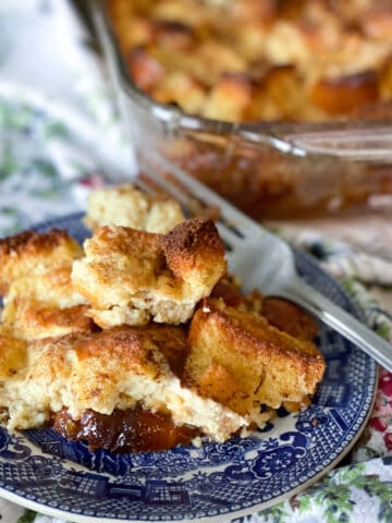 French toast casserole on a blue plate with a fork nearby.
