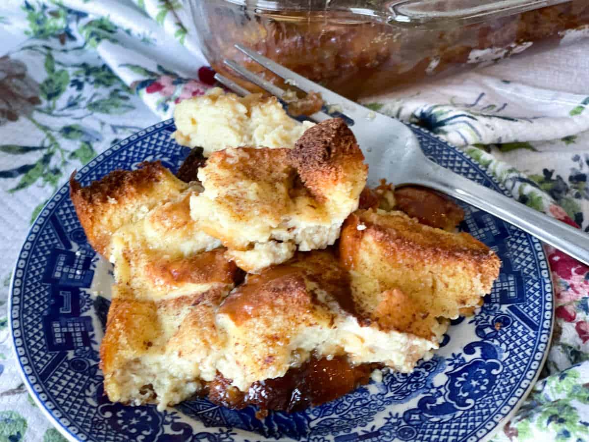 French toast casserole on a blue and white plate with a fork in the background.