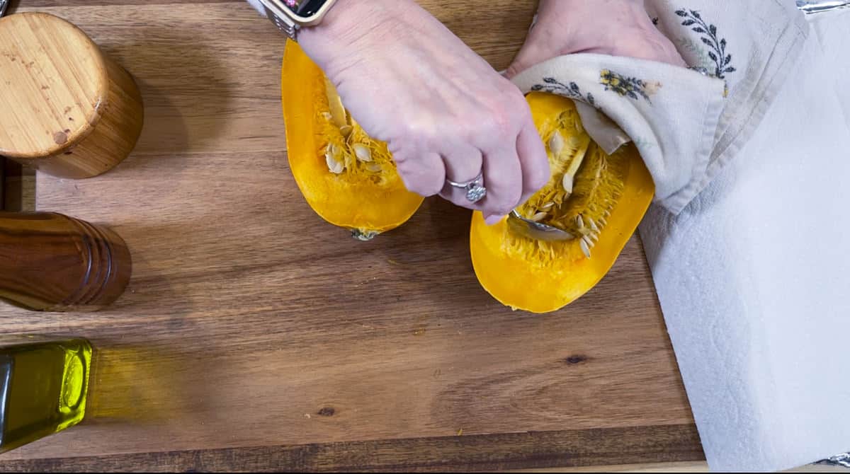 Scraping out seeds from squash.