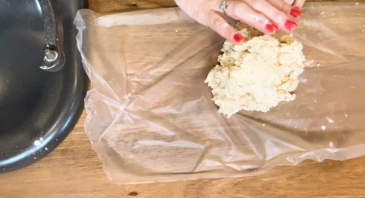 pouring the teacake dough out on to plastic wrap.