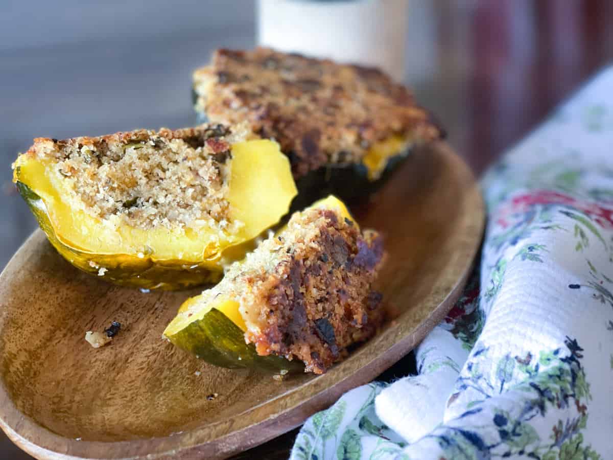 a wooden platter of stuffed acorn squash.