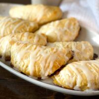 Glazed hand pies on a plate.