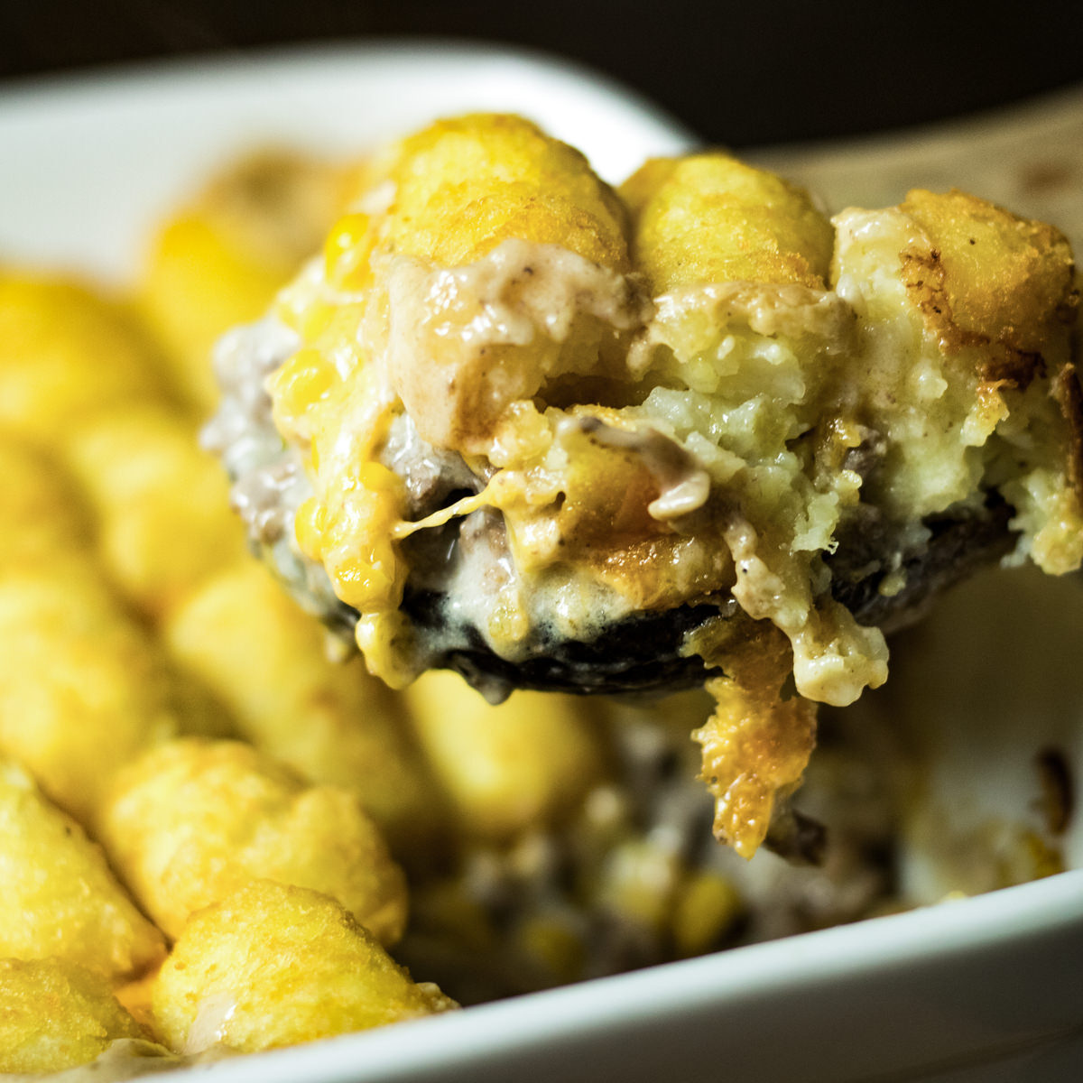 a spoon full of tater tot casserole