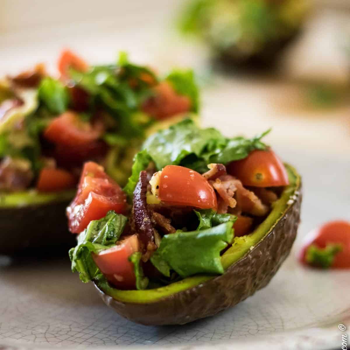 baked bt avocados stuffed with bacon and tomatoes.