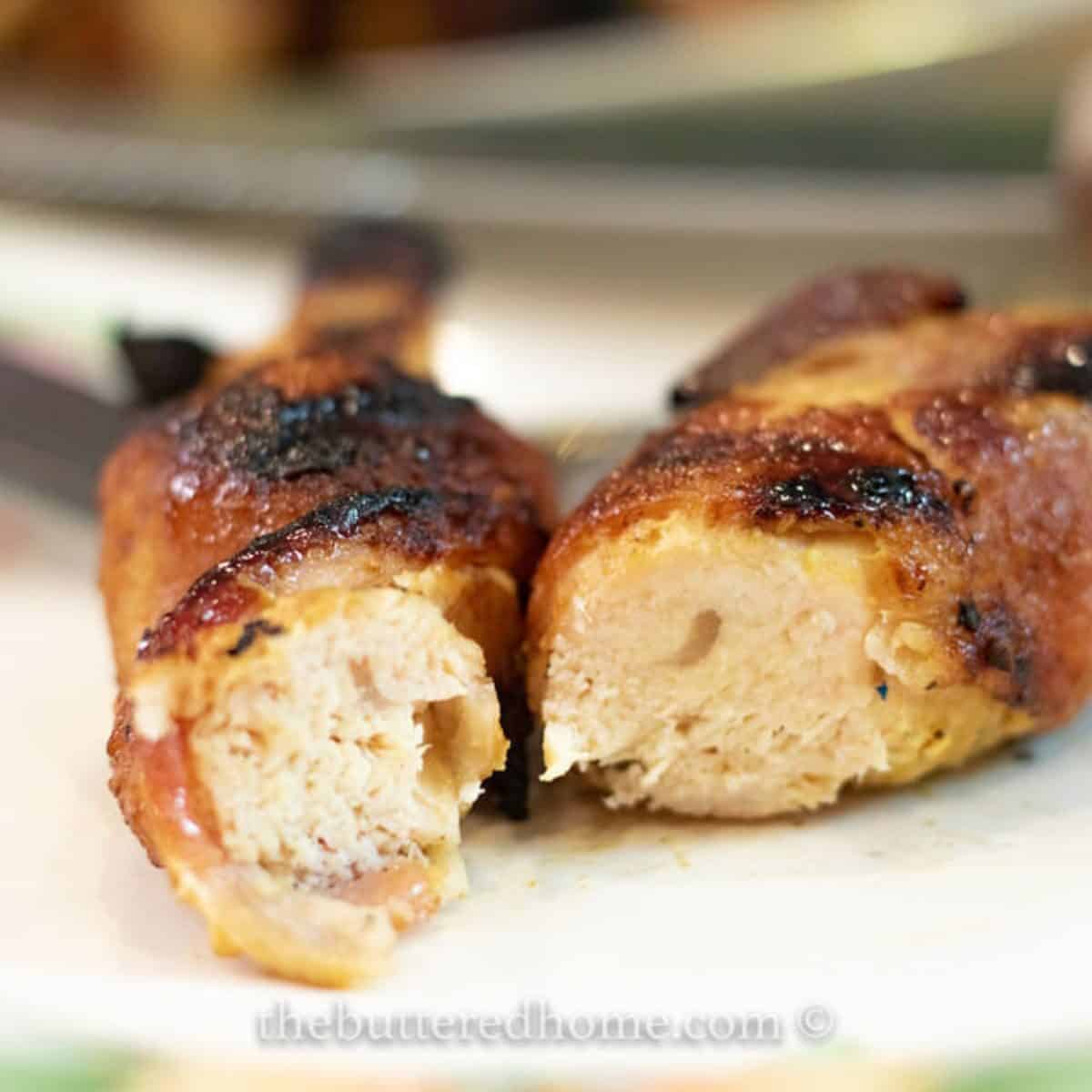 a piece of grilled Hawaiian chicken cut in half on a floral plate