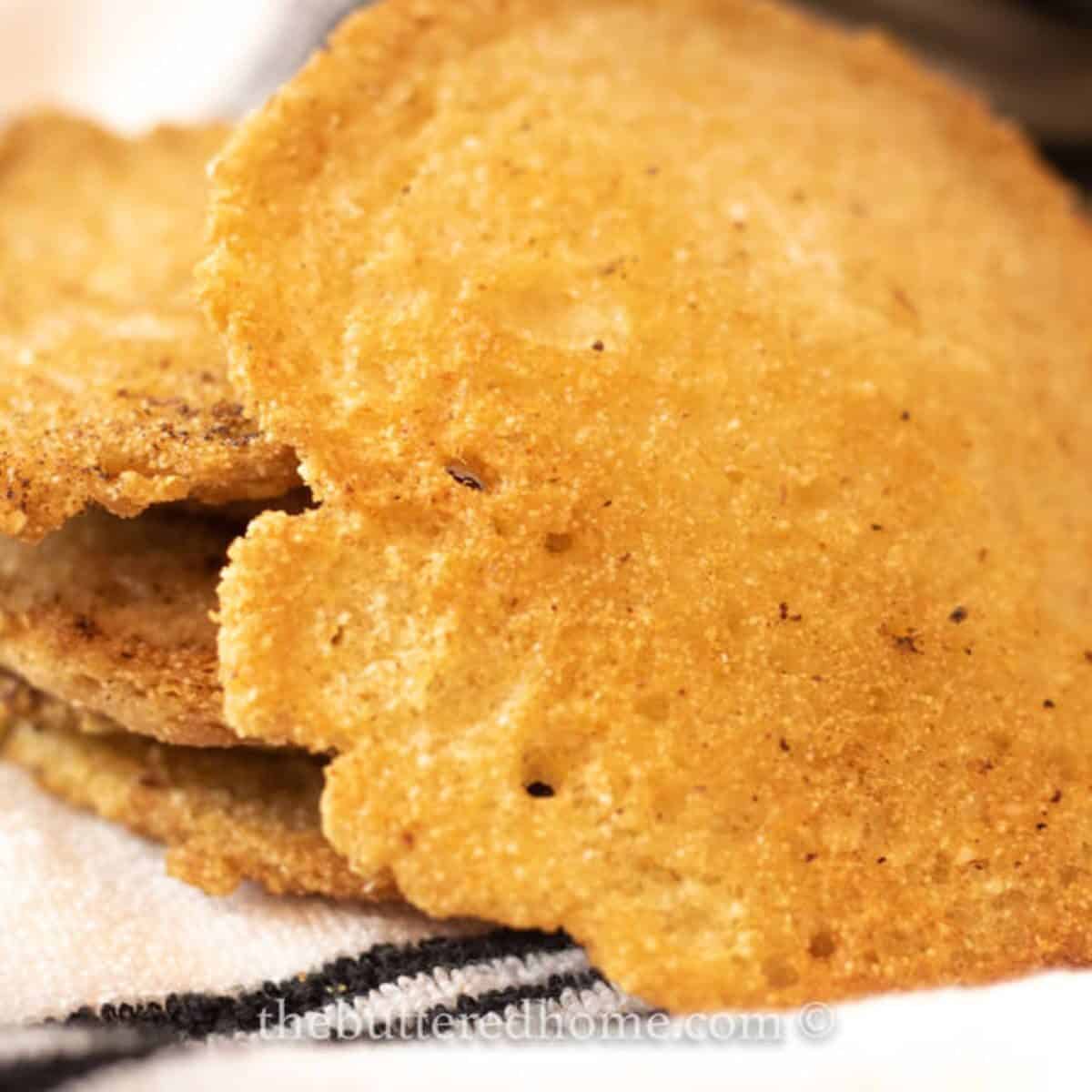 a stack of lace cornbread on a tea towel