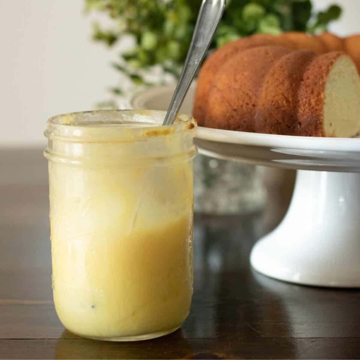 lemon curd with a pound cake in the background.