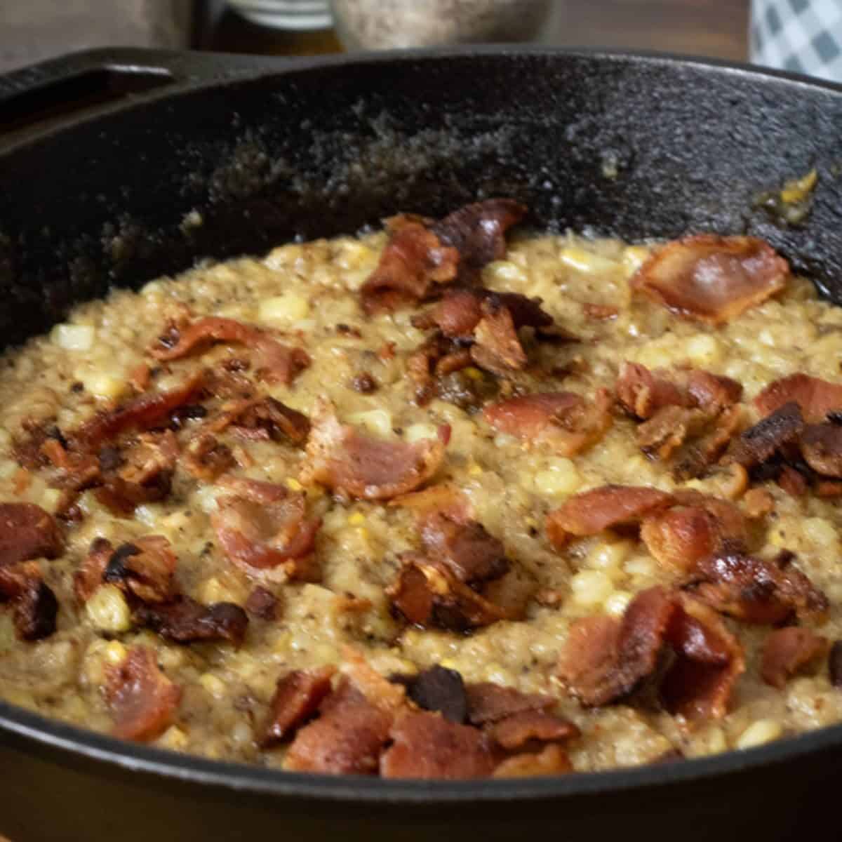 Cast Iron pan with bacon and skillet fried corn.