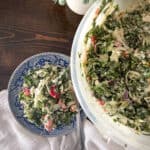 Colorful green salad on a blue willow plate.