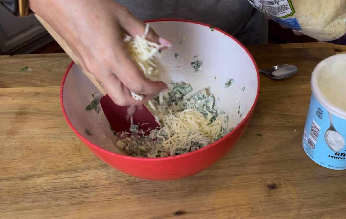 Adding shredded mozzarella.