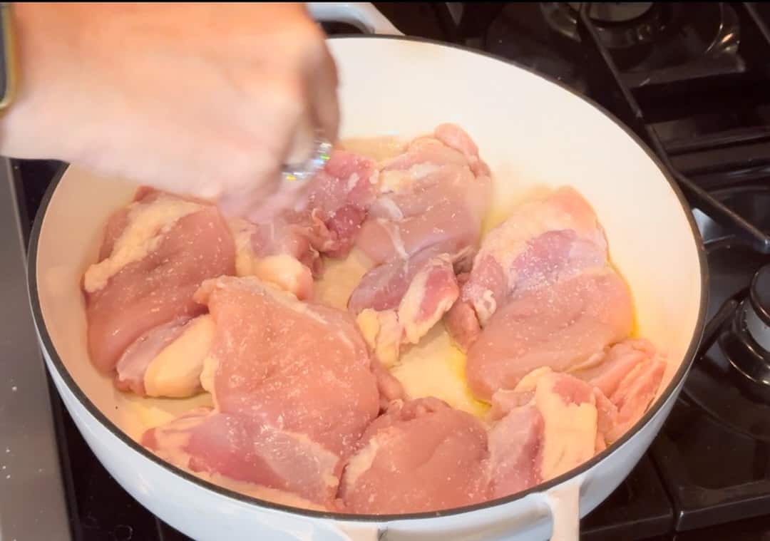 Adding salt to chicken.