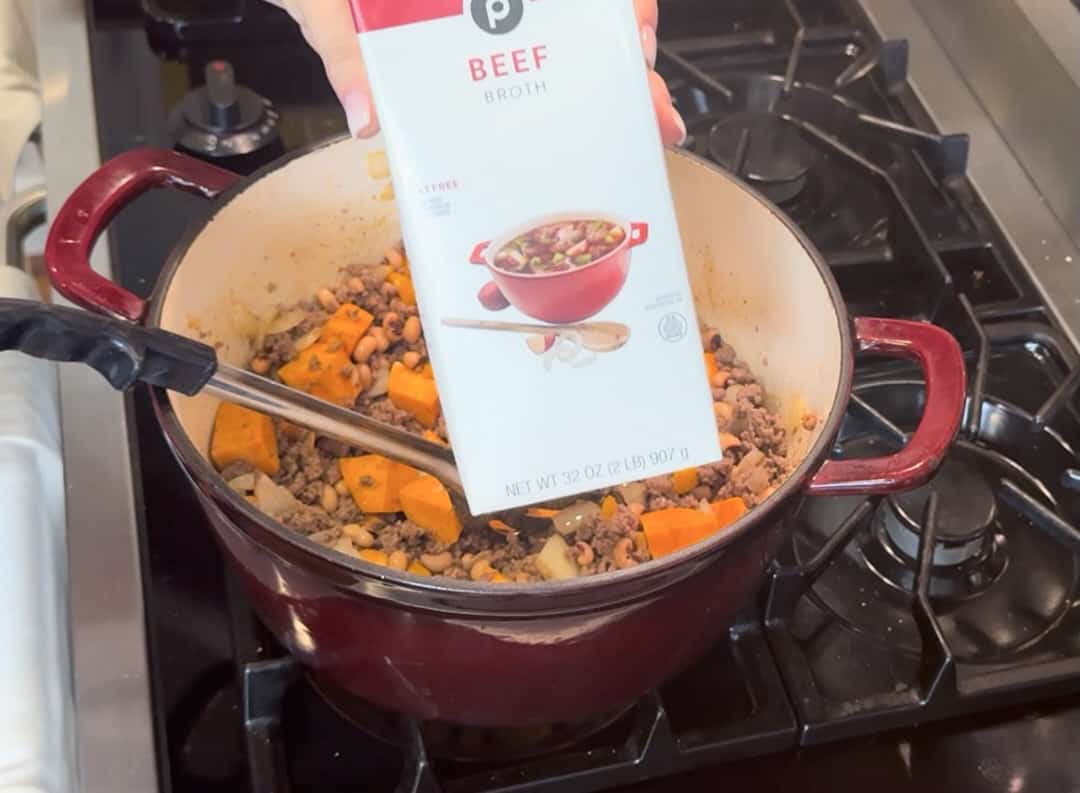 Adding beef broth to simmer.