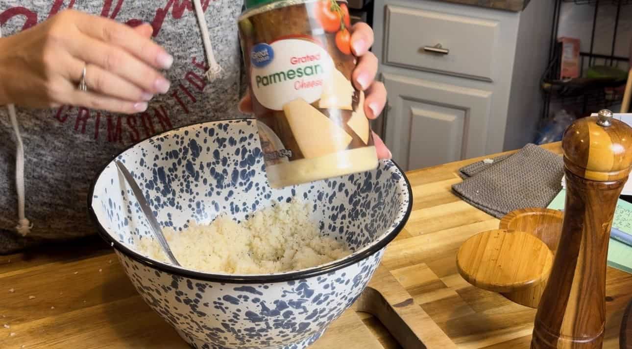 Adding Parmesan Cheese.