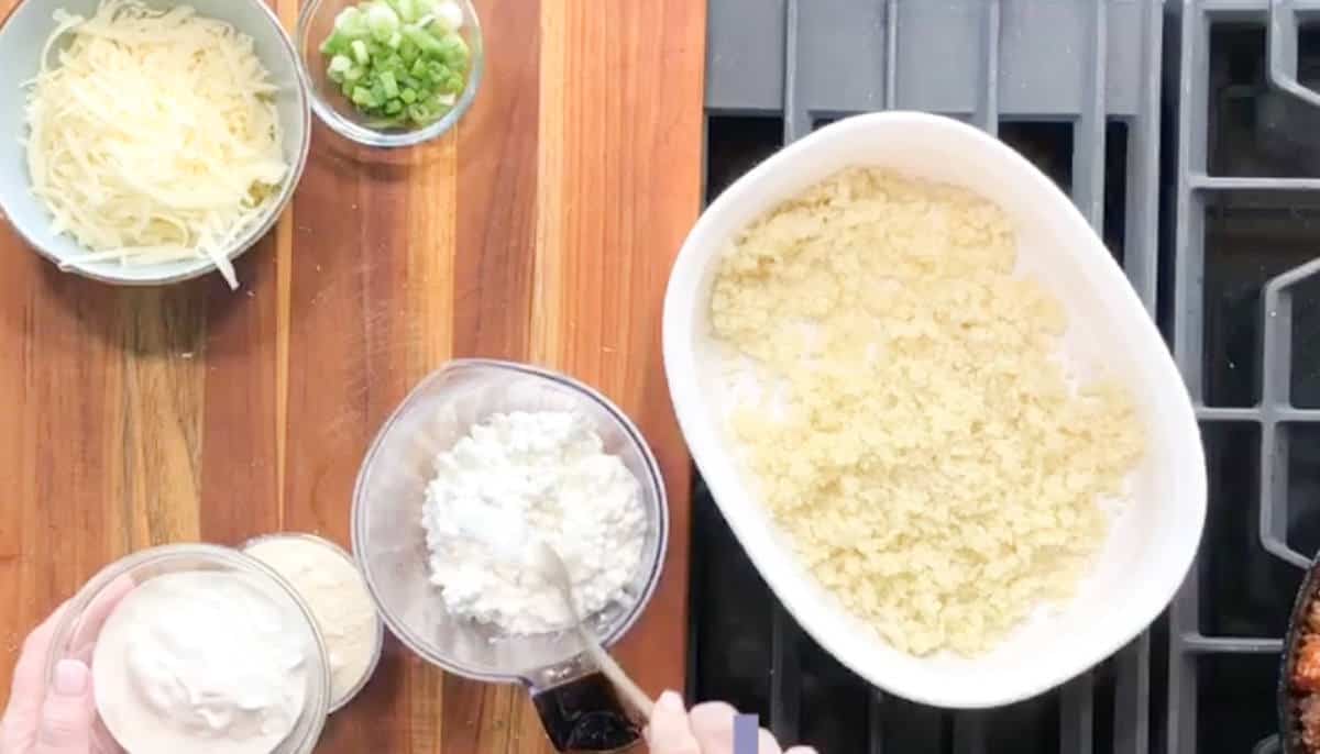 Adding sour cream to cottage cheese.