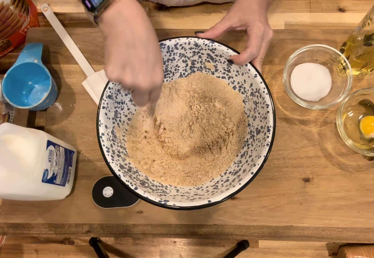 Mixing flours in a blue and white bowl.