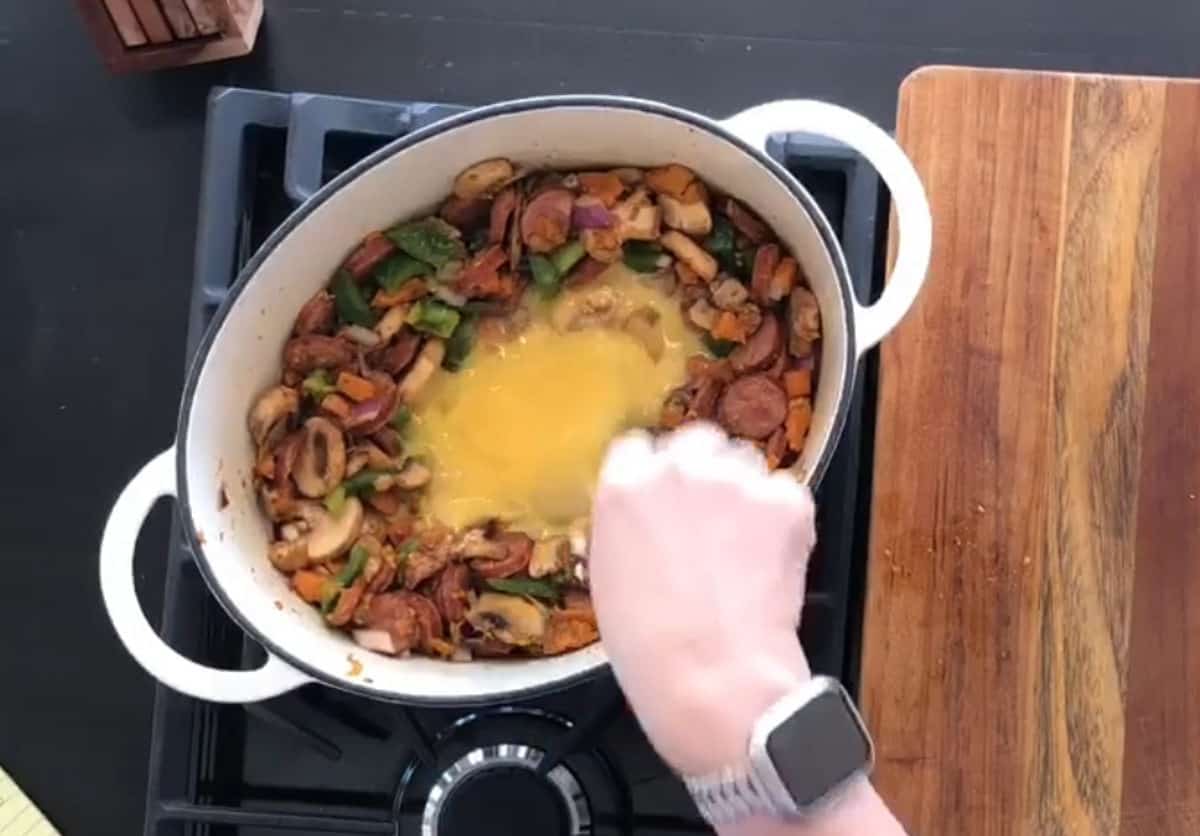 Adding eggs in to scramble