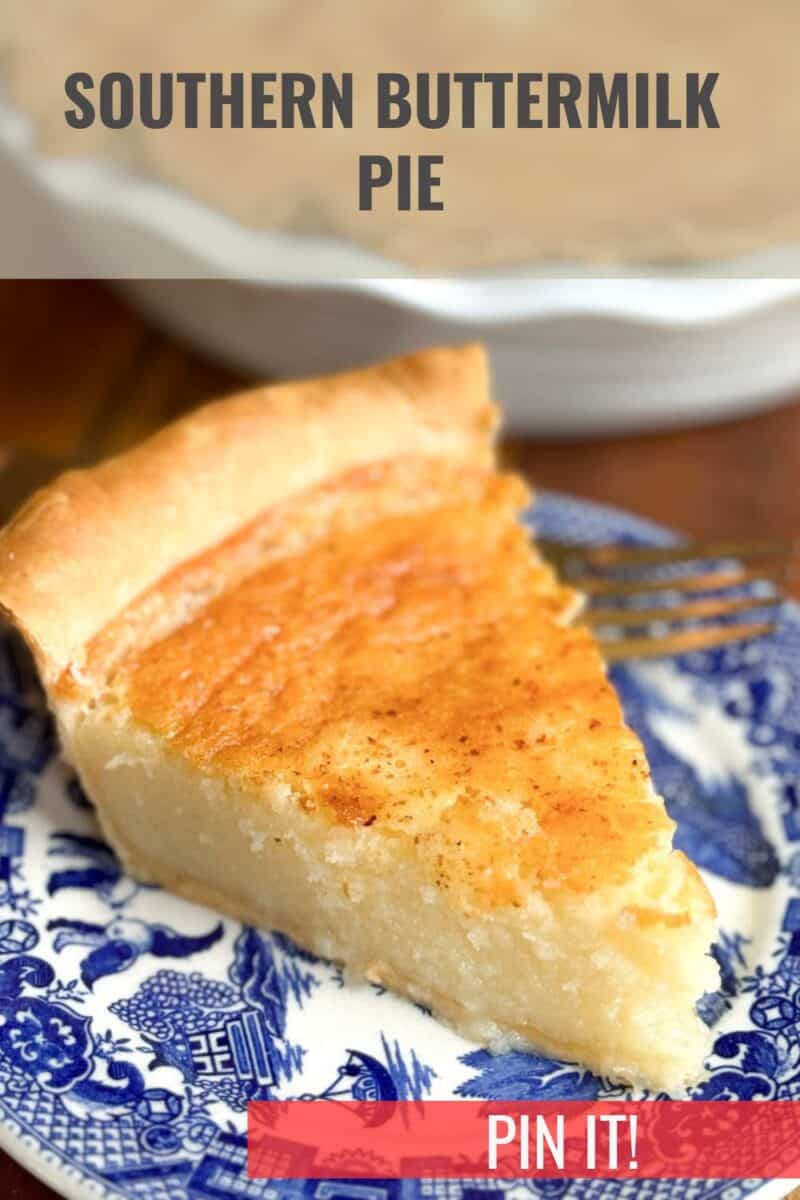 A slice of Southern Buttermilk Pie is placed on a blue and white patterned plate. The background features a pie dish with the remaining pie, blurred out. Text at the top reads "Southern Buttermilk Pie" and "Pin it!" is displayed in a red banner at the bottom.
