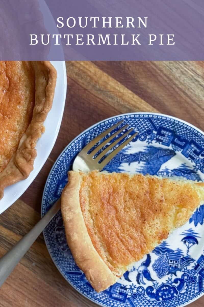 A slice of Southern buttermilk pie on a blue and white plate is placed next to the rest of the pie in a white dish. A gold fork rests near the pie slice. The wooden surface under the plate and dish is visible. The text "Southern Buttermilk Pie" appears at the top.