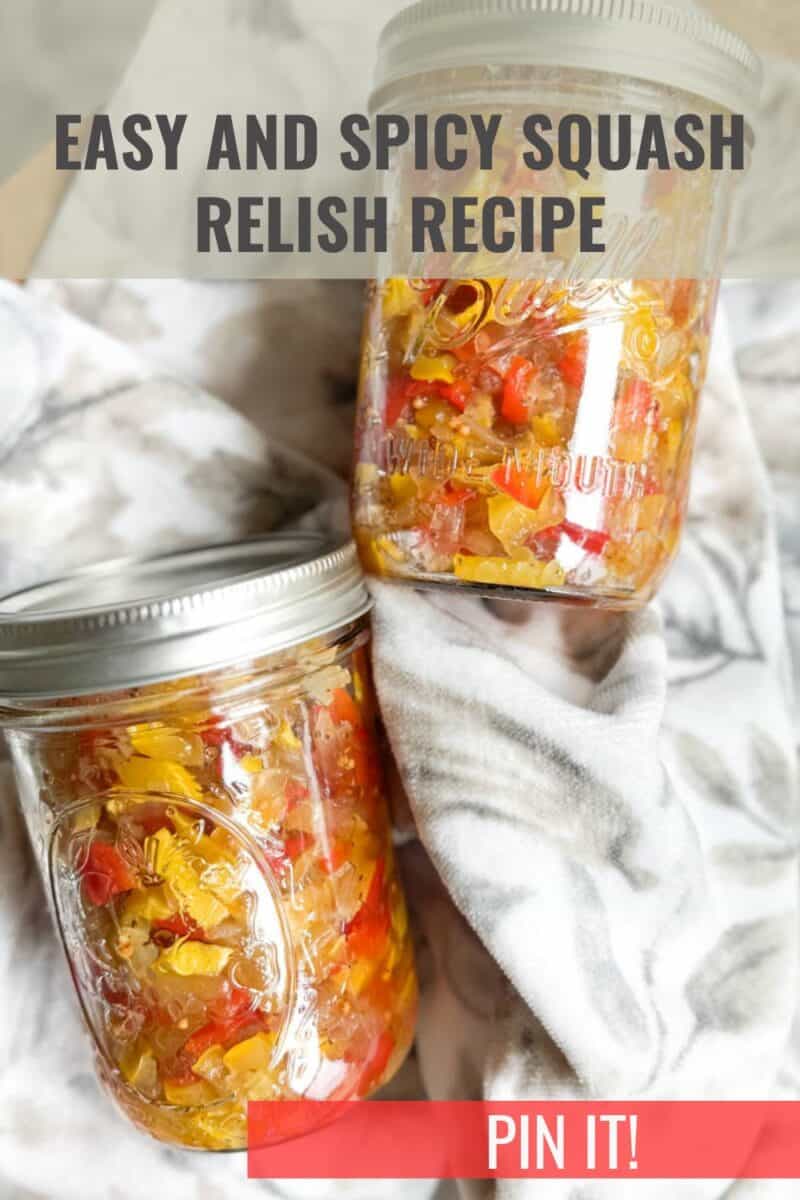 Two glass jars filled with a colorful squash relish mixture sit on a white and gray patterned fabric. The text on the image reads "Easy and Spicy Squash Relish Recipe" at the top and "Pin It!" in a red banner at the bottom.