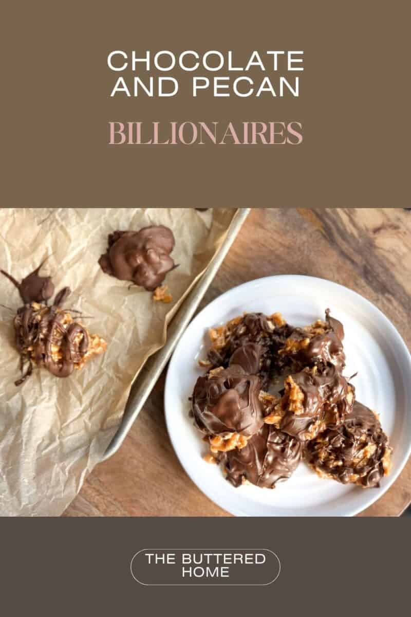 A wooden surface features a white plate with chocolate and pecan clusters. Additional clusters sit on brown parchment paper. The text above reads "Chocolate and Pecan Billionaires" and below is a logo saying "The Buttered Home.