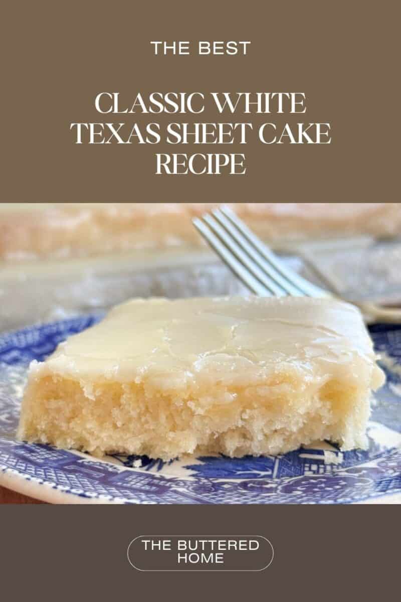 A slice of white Texas sheet cake with glaze on top rests on a blue and white patterned plate. A fork is placed in the background. Text at the top reads "The Best Classic White Texas Sheet Cake Recipe," and "The Buttered Home" at the bottom.
