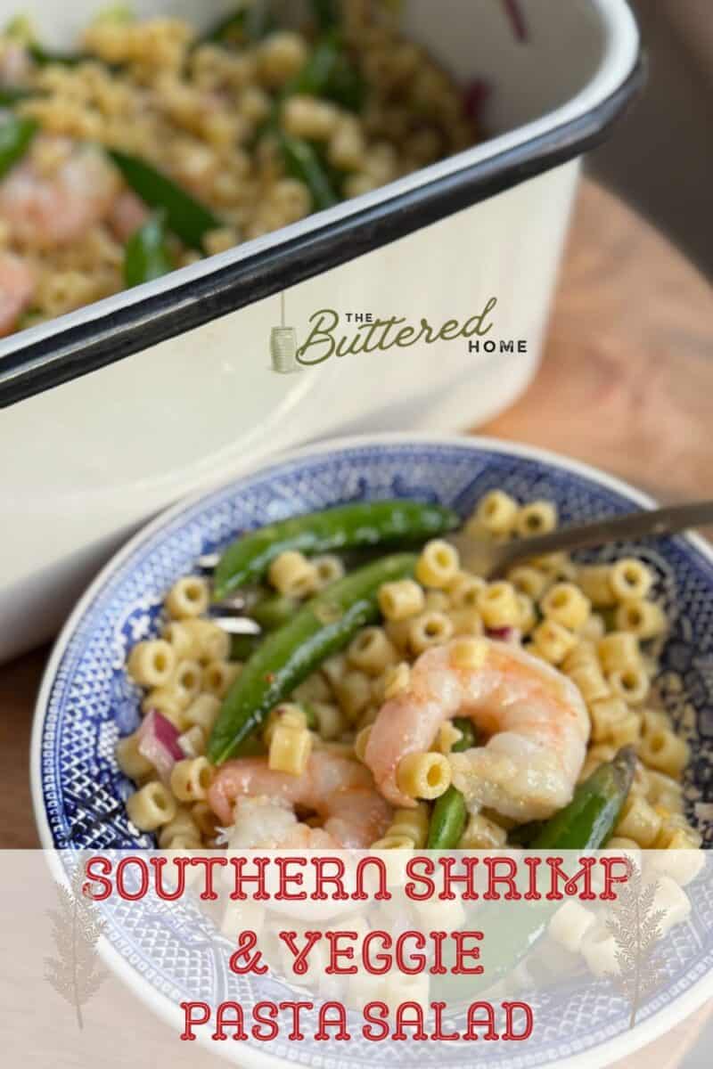 A bowl of pasta salad with shrimp, peas, and corn sits in the foreground. A large white dish with more salad is in the background. Text on the image reads "The Buttered Home: Southern Shrimp & Veggie Pasta Salad.