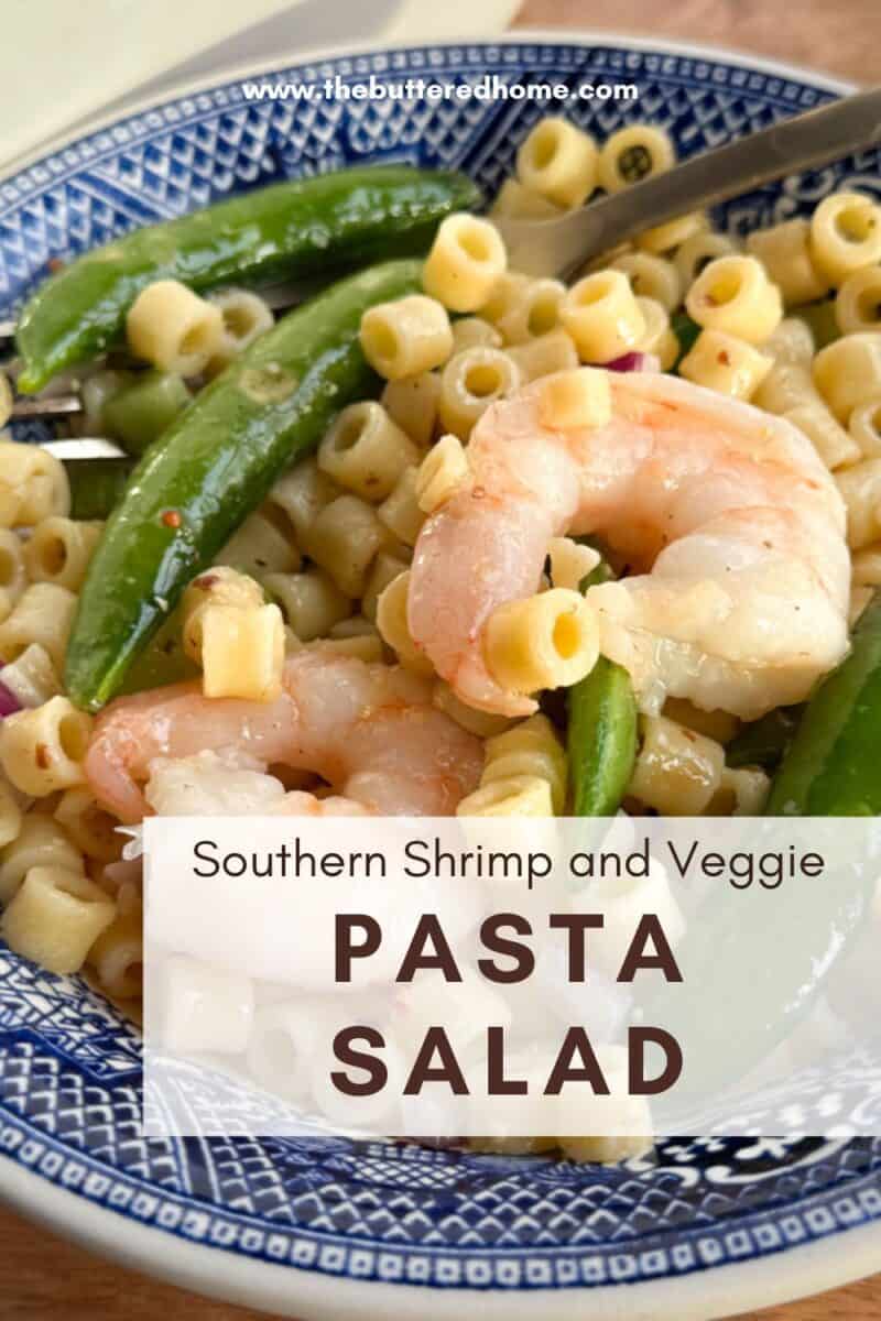A ceramic bowl filled with pasta salad, featuring shrimp, pea pods, and small pasta tubes. The text on the image reads "Southern Shrimp and Veggie Pasta Salad." The bowl has a blue and white pattern.