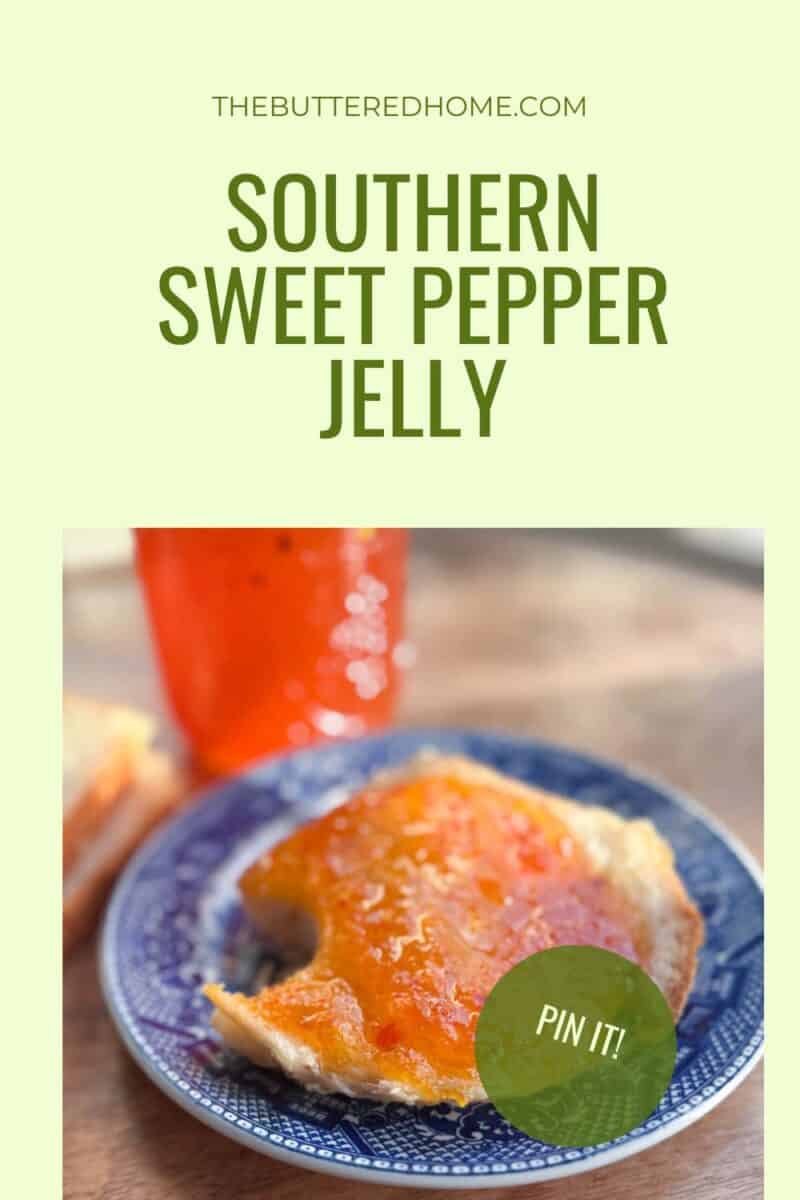 A close-up of a biscuit topped with orange sweet pepper jelly on a blue plate. In the background, there is a jar of the jelly. The text reads "THEBUTTEREDHOME.COM SOUTHERN SWEET PEPPER JELLY." A green sticker says "PIN IT!.