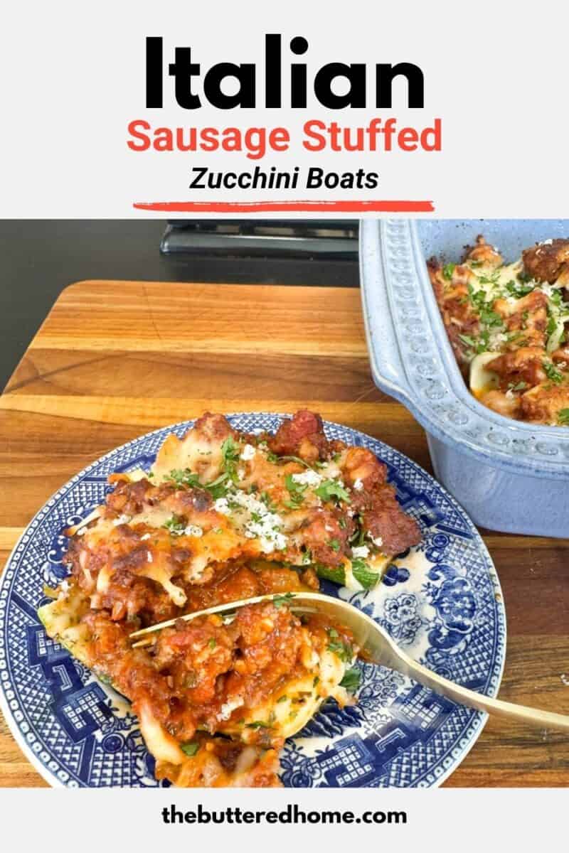 A blue and white plate holds two Italian sausage stuffed zucchini boats topped with sauce and herbs. A fork rests on the plate. Nearby, a blue baking dish contains more zucchini boats on a wooden cutting board.
