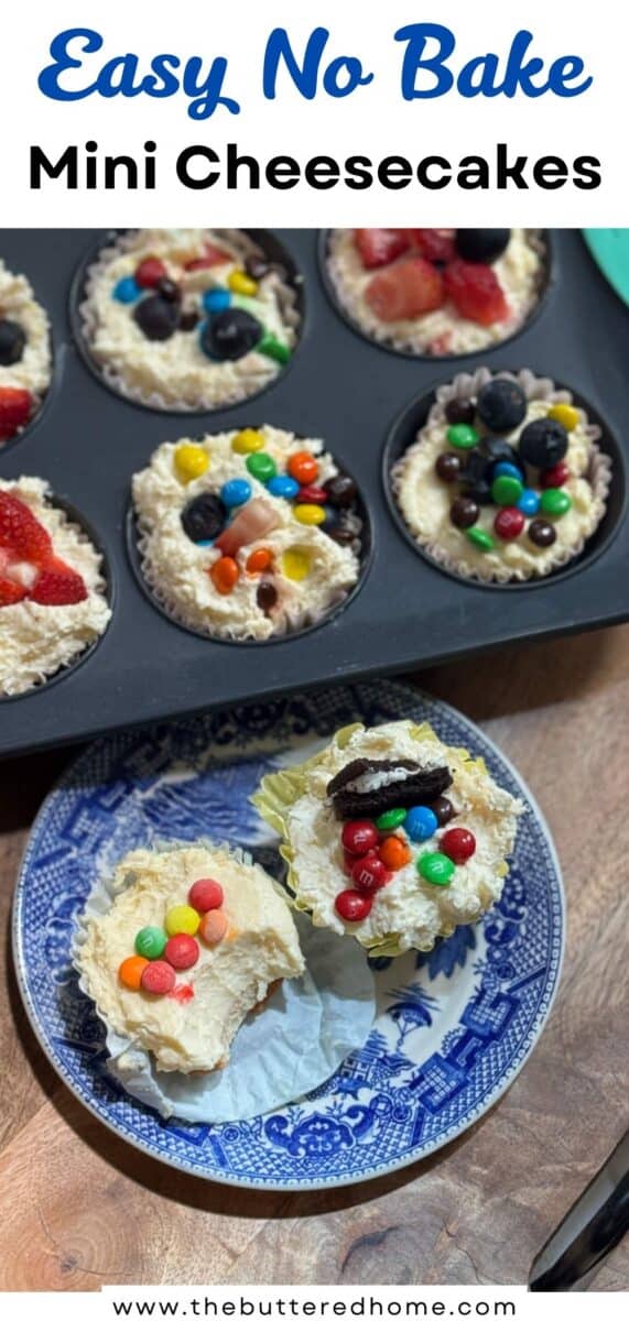 A muffin tin with mini no-bake cheesecakes topped with fruit and candies sits on a wooden surface. Two cheesecakes are on a blue and white plate, also topped with colorful candies.