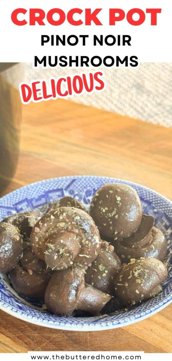 A blue and white patterned bowl filled with cooked whole mushrooms sits on a wooden surface. Text above reads "CROCK POT PINOT NOIR MUSHROOMS DELICIOUS" with a website link at the bottom.