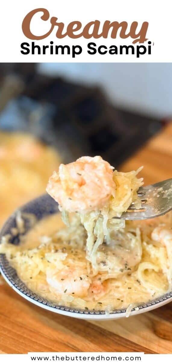 A fork holds a serving of creamy shrimp scampi above a patterned bowl filled with shrimp, pasta, and creamy sauce. The background is blurred, and the dish sits on a wooden surface.